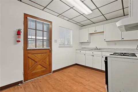 a kitchen with granite countertop white cabinets and white appliances
