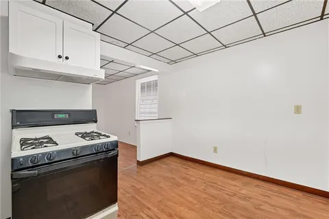 a kitchen with granite countertop a stove and a microwave