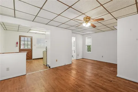 a view of empty room with wooden floor