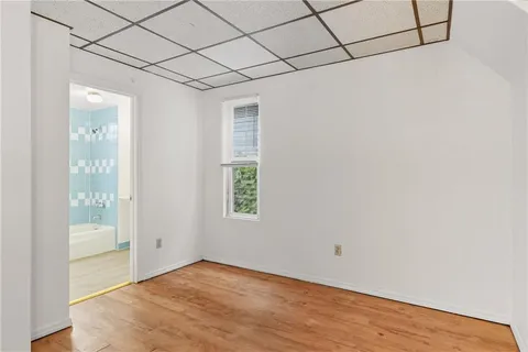 a view of a room with wooden floor and windows