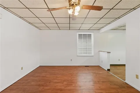 a view of a room with wooden floor and windows