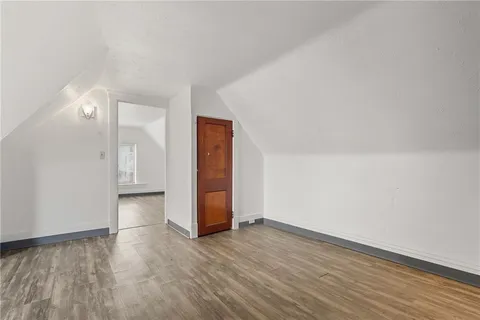 a view of an empty room and wooden floor