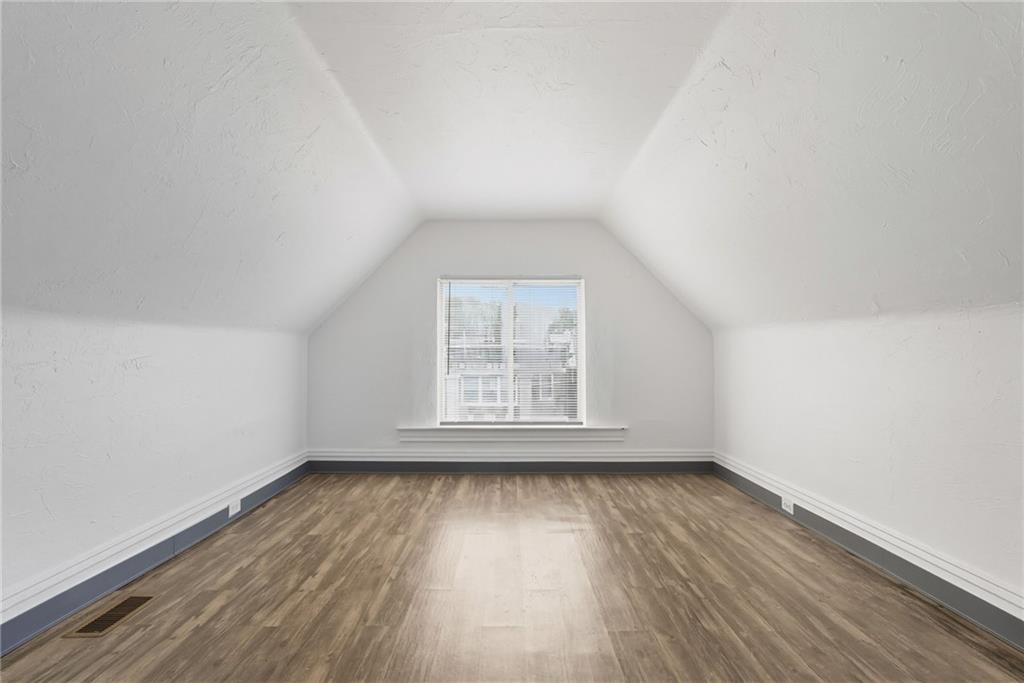 705 Russellwood Avenue McKees Rocks, PA 15136 - Photo 17 of 37 an empty room with wooden floor and windows