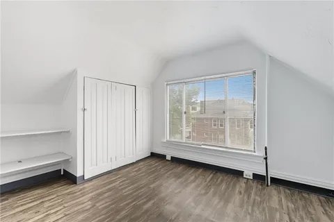 a view of wooden floor and windows in a room