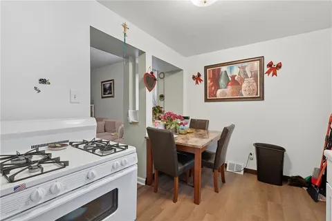 a kitchen with a stove and white cabinets