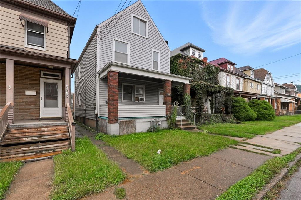 705 Russellwood Avenue McKees Rocks, PA 15136 - Photo 3 of 37 a view of a house with a yard porch and a street