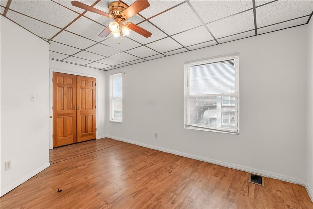 705 Russellwood Avenue McKees Rocks, PA 15136 - Photo 7 of 37 a view of an empty room with wooden floor and a window