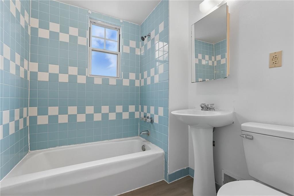 705 Russellwood Avenue McKees Rocks, PA 15136 - Photo 8 of 37 a bathroom with a sink a toilet and bathtub