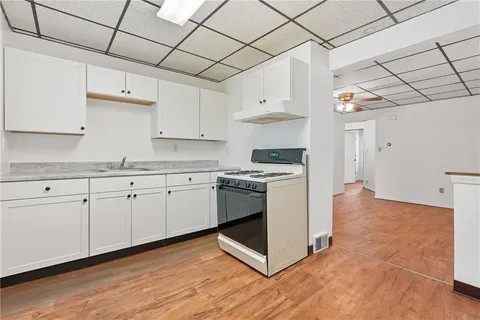 a kitchen with granite countertop white cabinets and white appliances