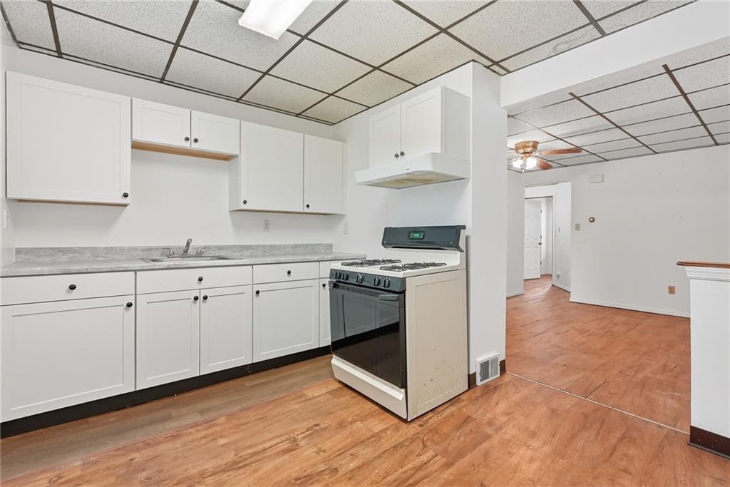 705 Russellwood Avenue McKees Rocks, PA 15136 - Photo 9 of 37 a kitchen with granite countertop white cabinets and white appliances