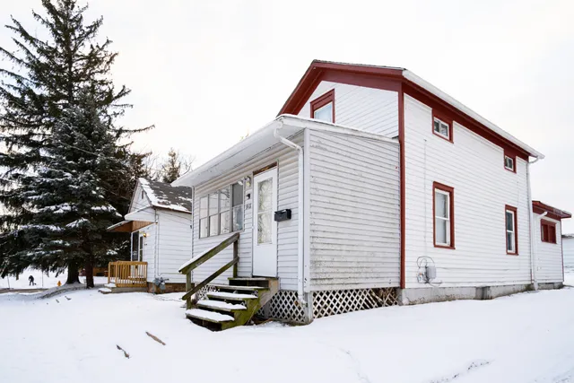 a front view of a house with a snow