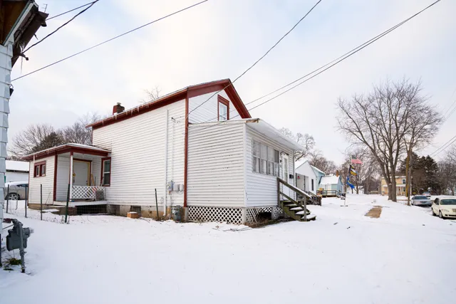 a view of a house with snow on the road