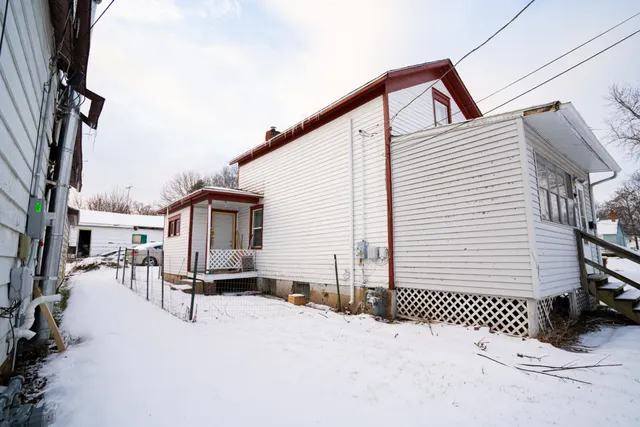 a view of a house with wooden fence