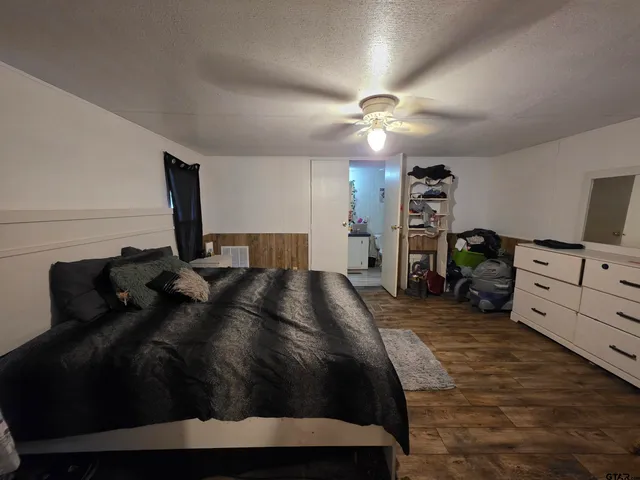 a bedroom with a bed window and closet