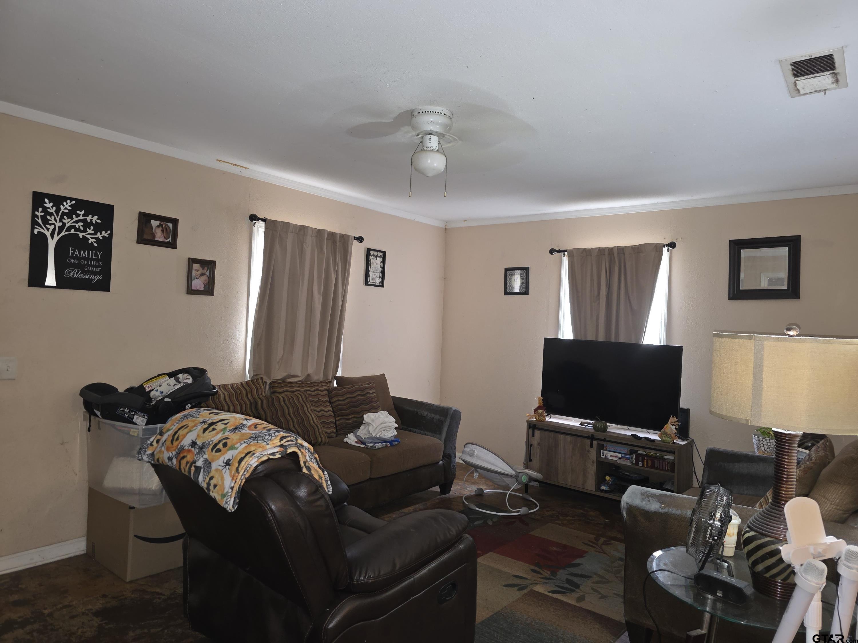 304 Walnut Street Naples, TX 75568 - Photo 15 of 28 a living room with furniture a flat screen tv and a window