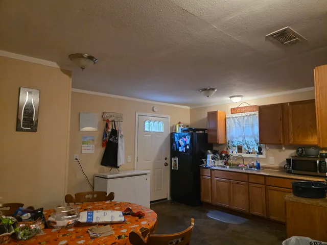 a kitchen with a sink stove and refrigerator
