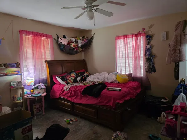 a bedroom with a bed and a window