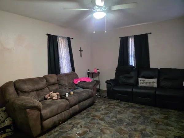 a living room with furniture and a chandelier