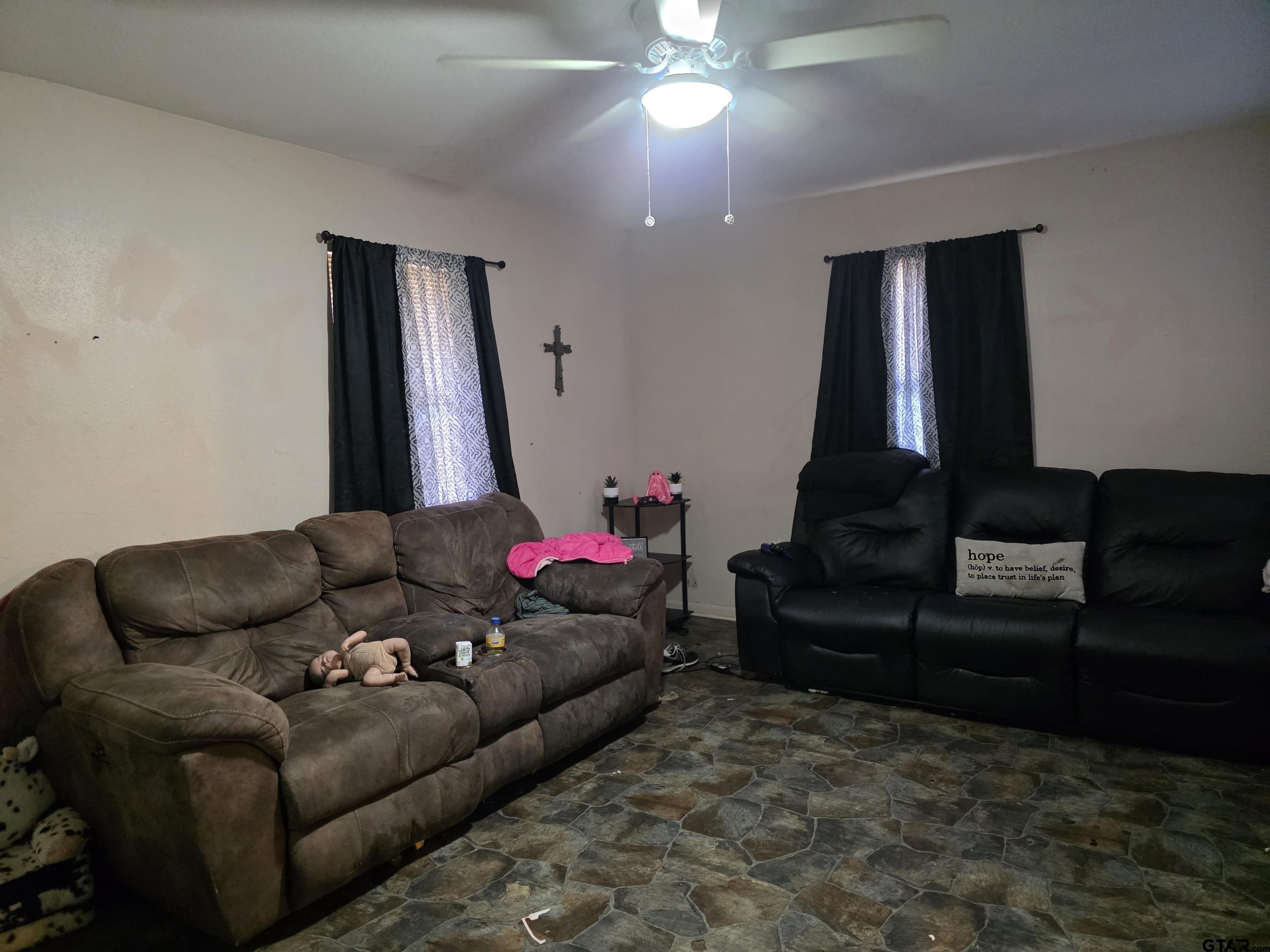 304 Walnut Street Naples, TX 75568 - Photo 22 of 28 a living room with furniture and a chandelier