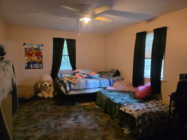 a bedroom with bed and a window