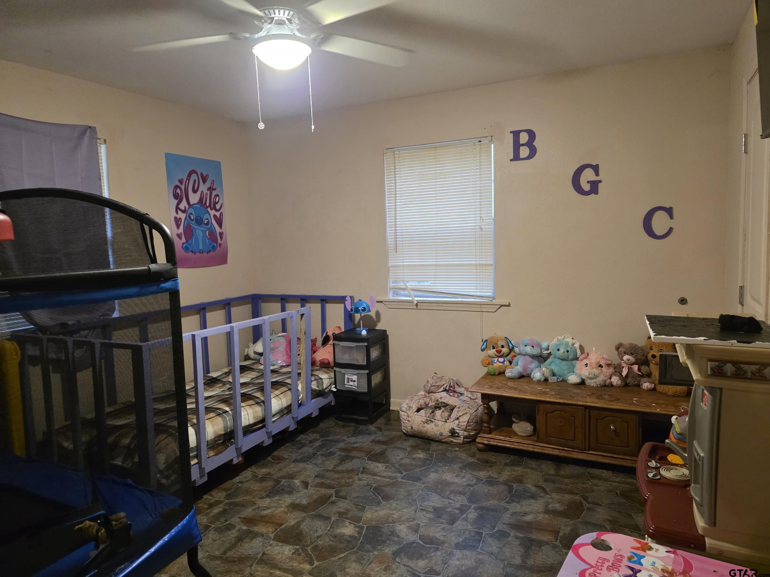 304 Walnut Street Naples, TX 75568 - Photo 24 of 28 a bedroom with furniture and a ceiling fan