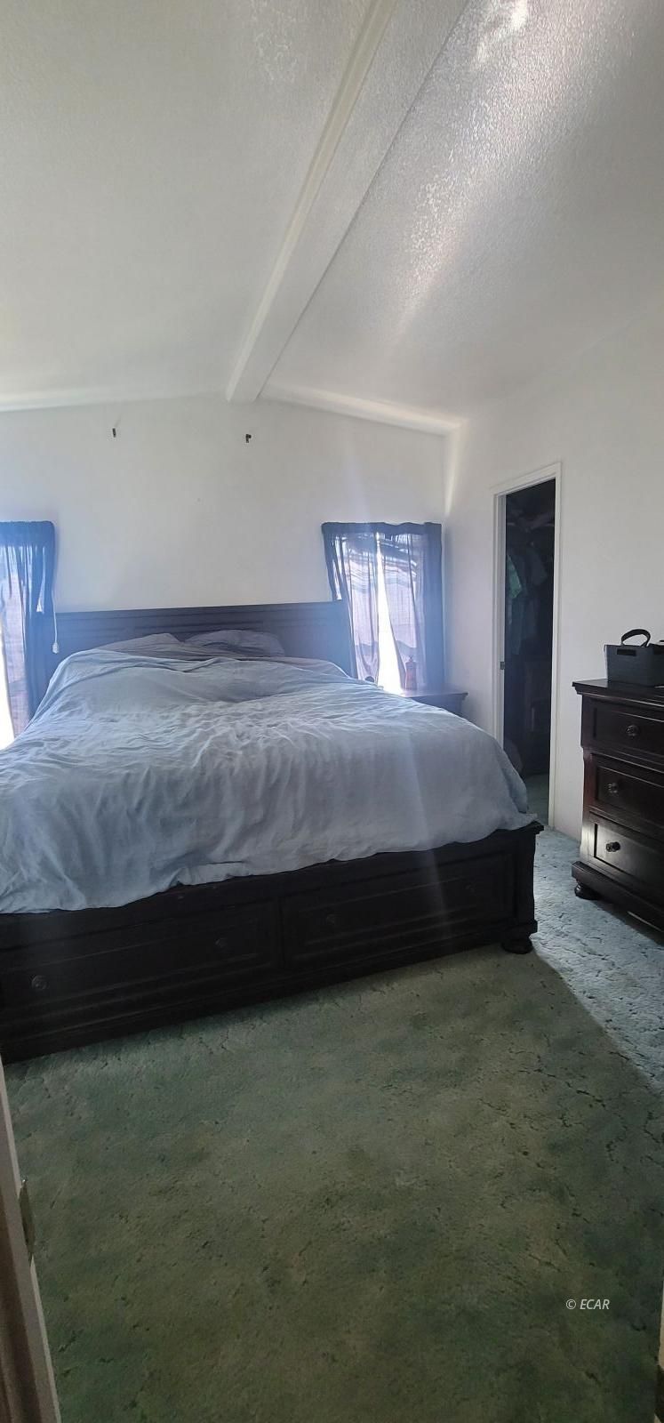 933 Spring Valley Parkway Spring Creek, NV 89815 - Photo 23 of 27 a bedroom with a bed dresser and a night stand