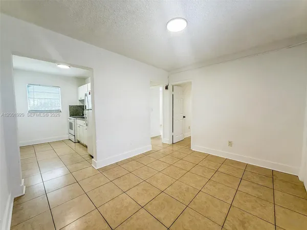an empty room with entrance and mirror