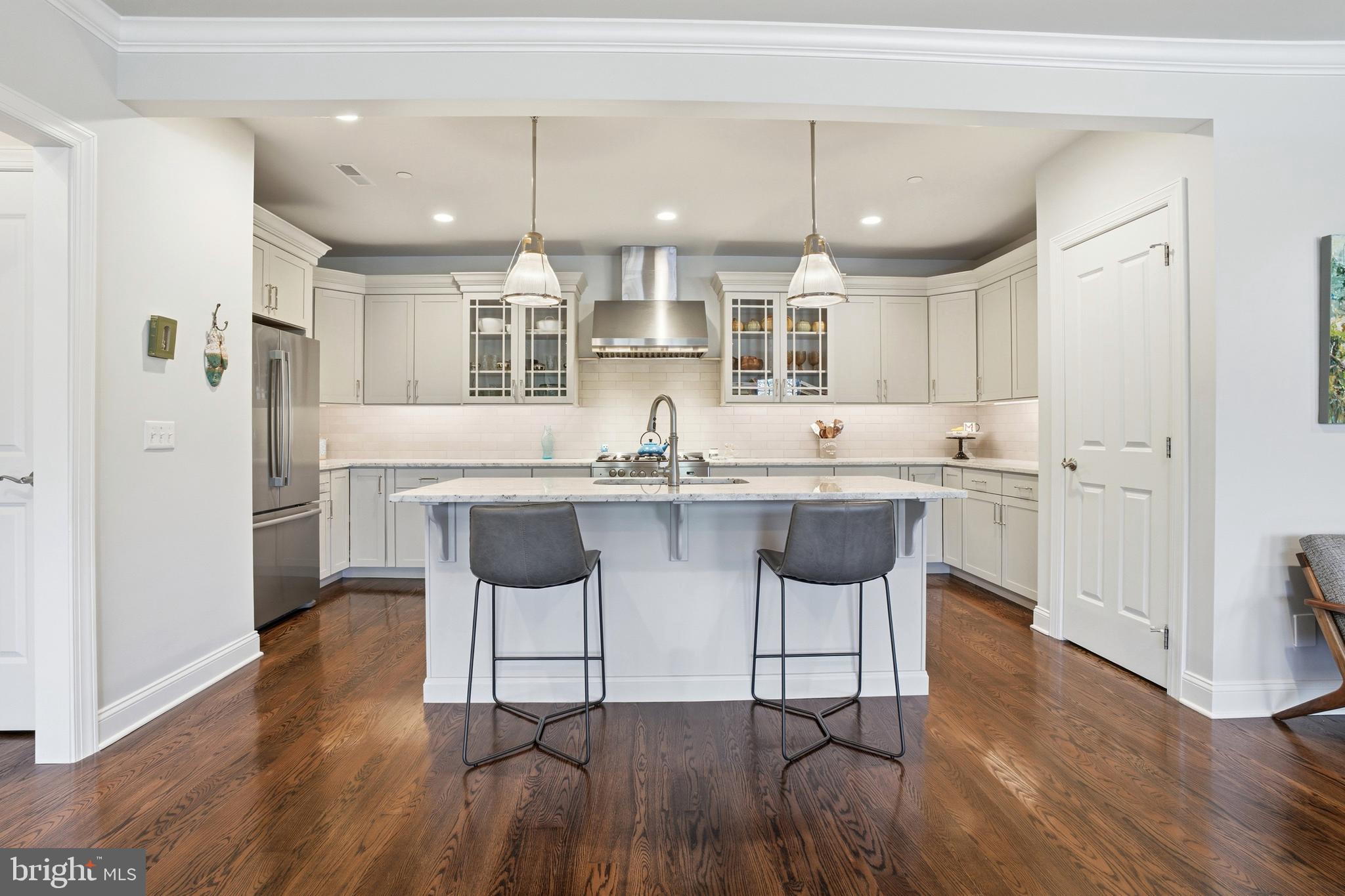 2401 Lower State Road, Unit 106 Doylestown, PA 18901 - Photo 12 of 56 a kitchen with stainless steel appliances kitchen island a refrigerator and cabinets