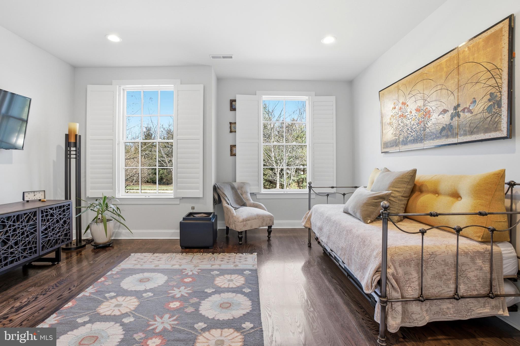 2401 Lower State Road, Unit 106 Doylestown, PA 18901 - Photo 22 of 56 a spacious bedroom with a bed a couch and large window