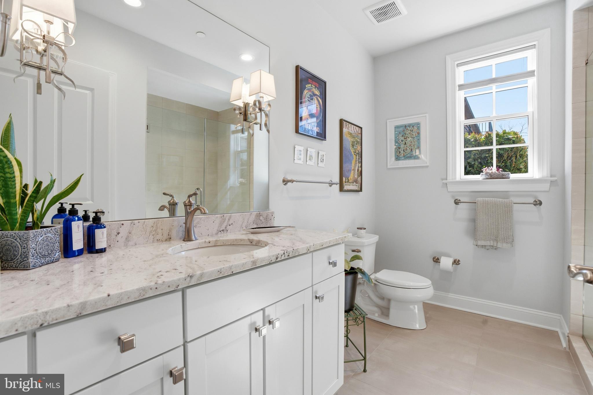 2401 Lower State Road, Unit 106 Doylestown, PA 18901 - Photo 23 of 56 a bathroom with a granite countertop toilet sink and mirror
