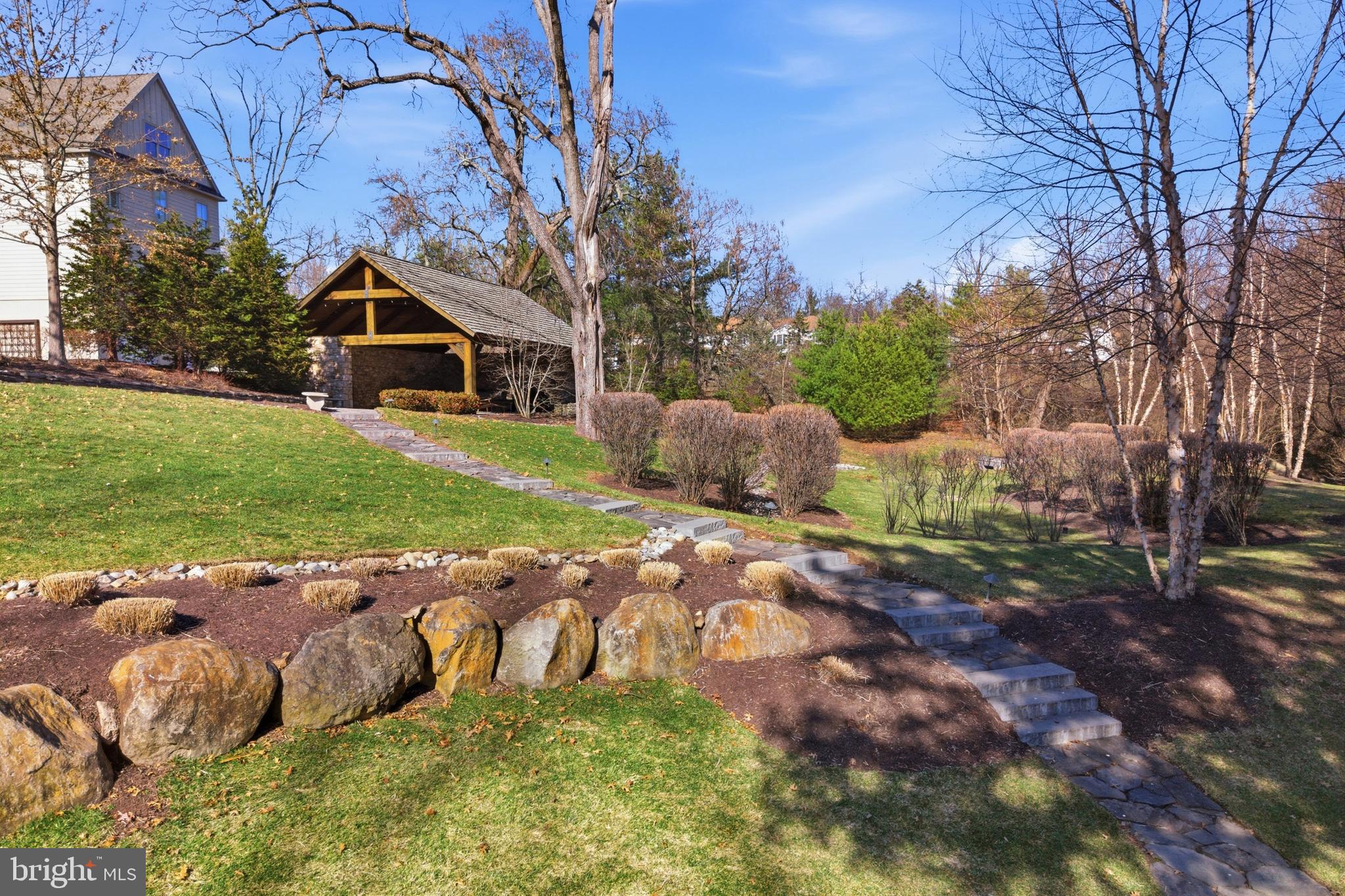 2401 Lower State Road, Unit 106 Doylestown, PA 18901 - Photo 51 of 56 a backyard of a house with table and chairs