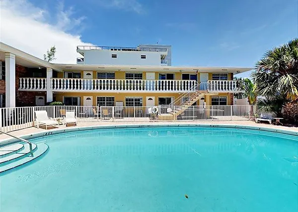 a view of swimming pool deck patio and garden