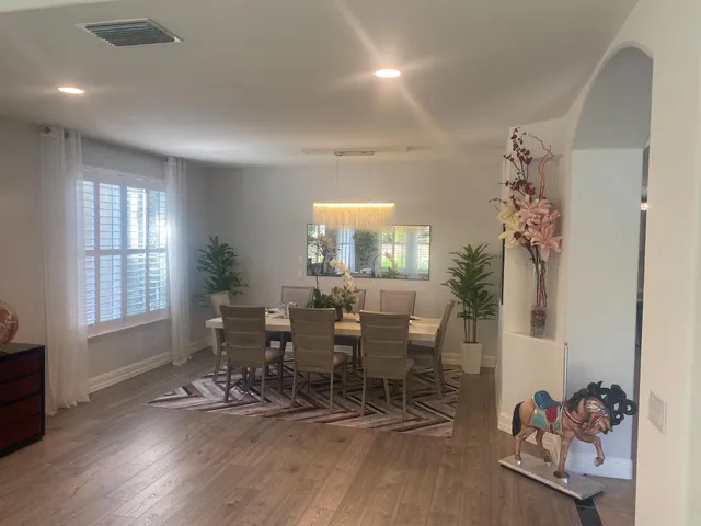 a large kitchen with a table and chairs in it