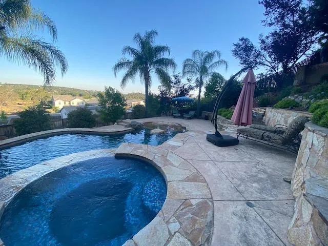 a view of a backyard with swimming pool