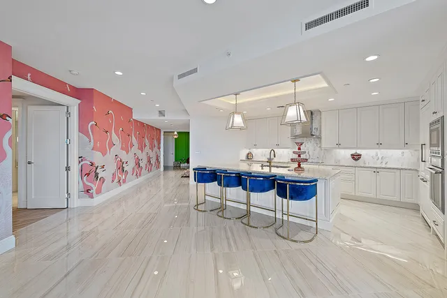 a kitchen with stainless steel appliances kitchen island granite countertop a sink and cabinets