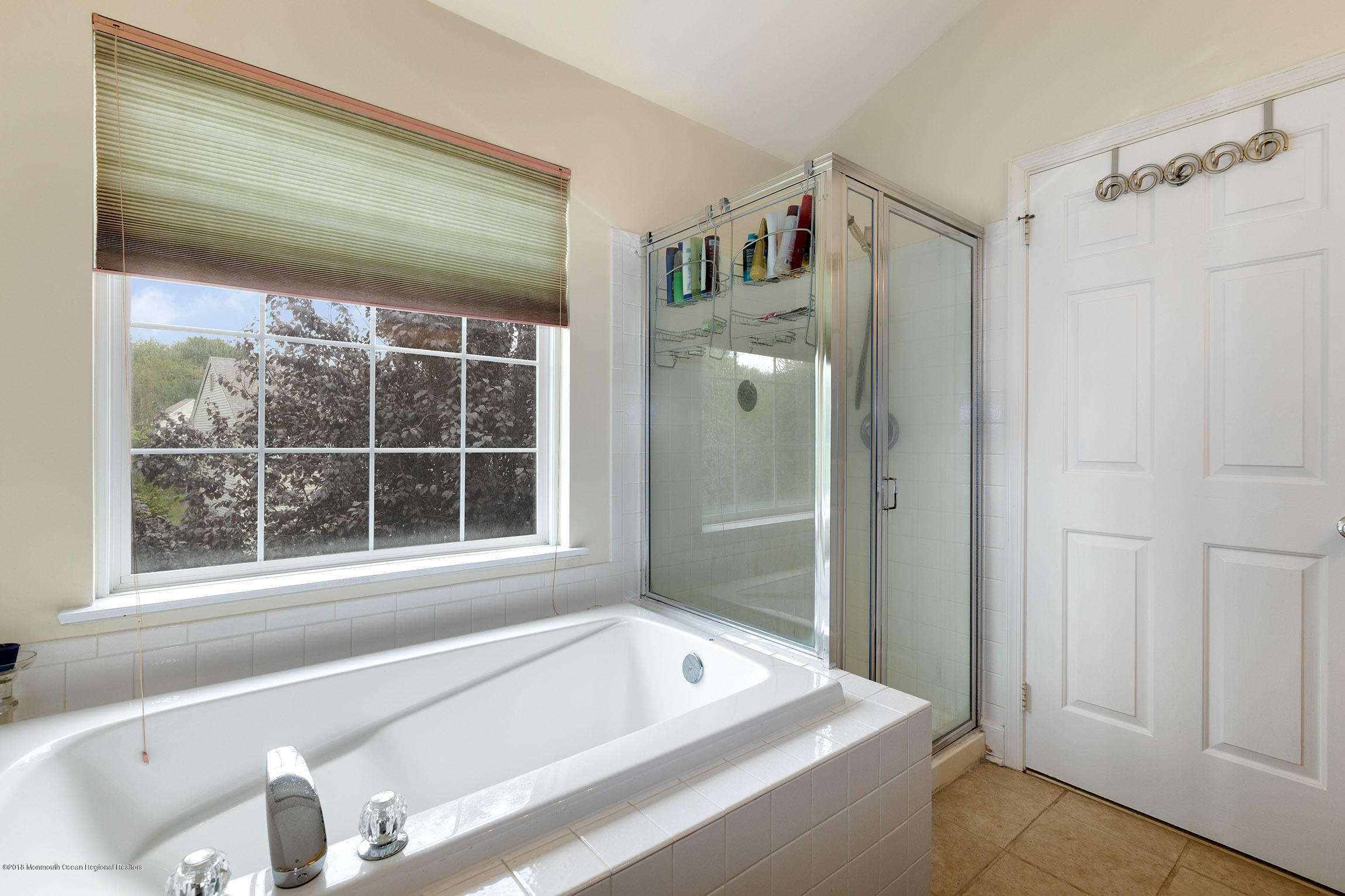 1 Lafayette Key Colts Neck, NJ 07722 - Photo 16 of 25 a bathroom with a tub and a window