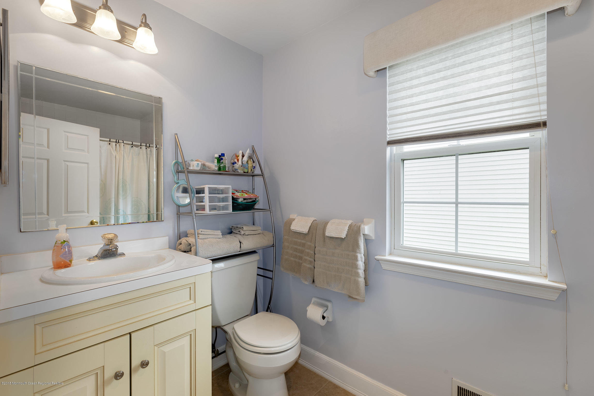 1 Lafayette Key Colts Neck, NJ 07722 - Photo 20 of 25 a bathroom with a sink a toilet and a window