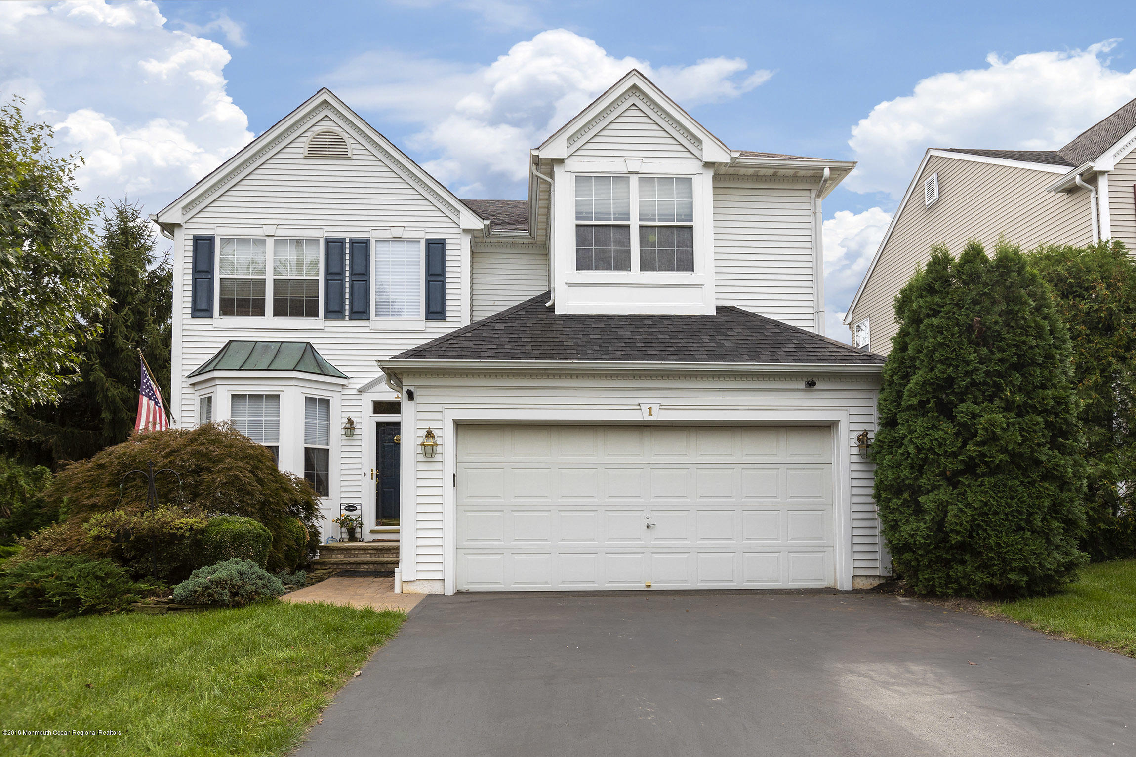 1 Lafayette Key Colts Neck, NJ 07722 - Photo 2 of 25 a front view of a house with a yard and garage