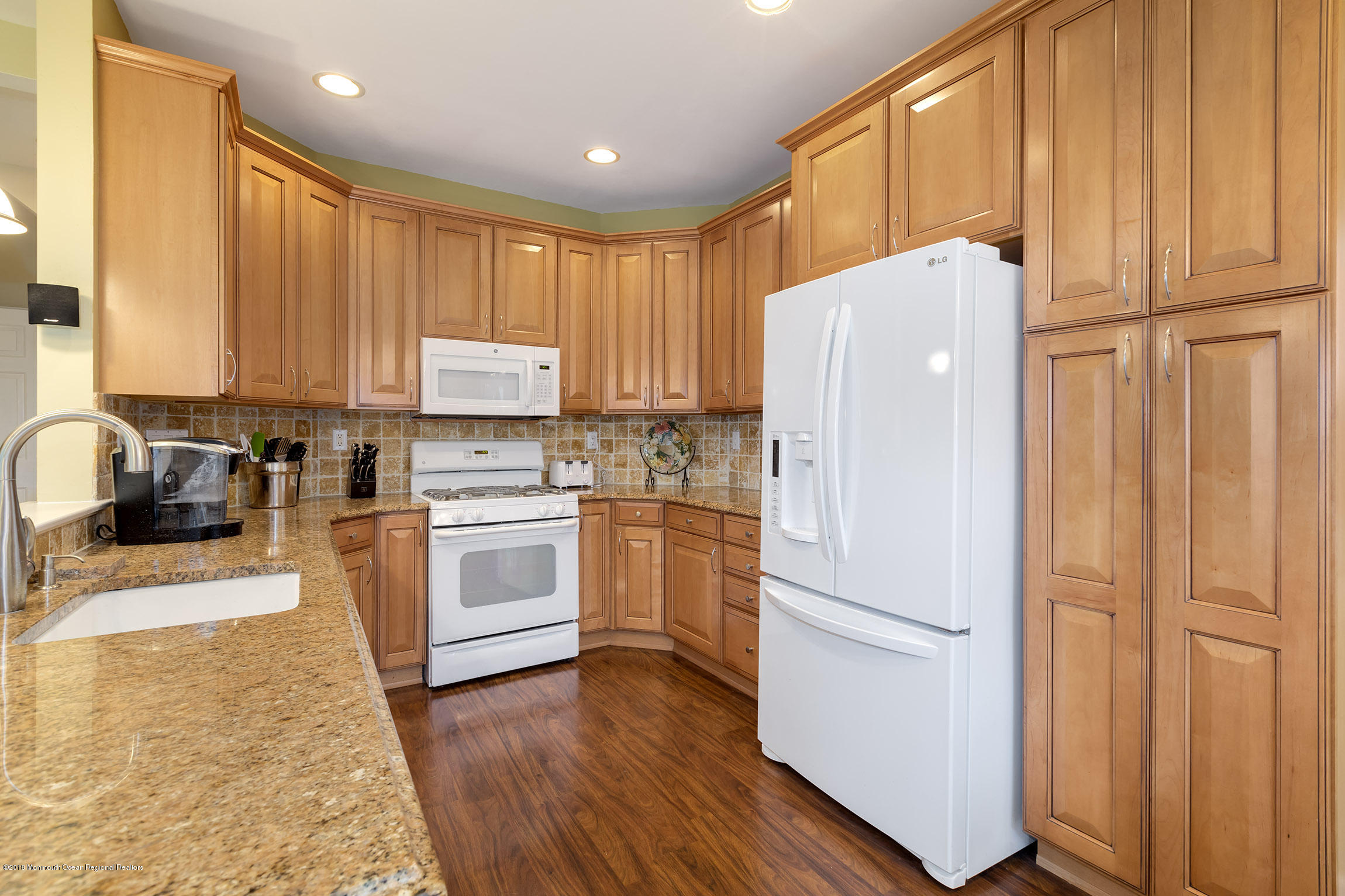 1 Lafayette Key Colts Neck, NJ 07722 - Photo 7 of 25 a kitchen with a refrigerator a stove top oven a sink and dishwasher with wooden floor