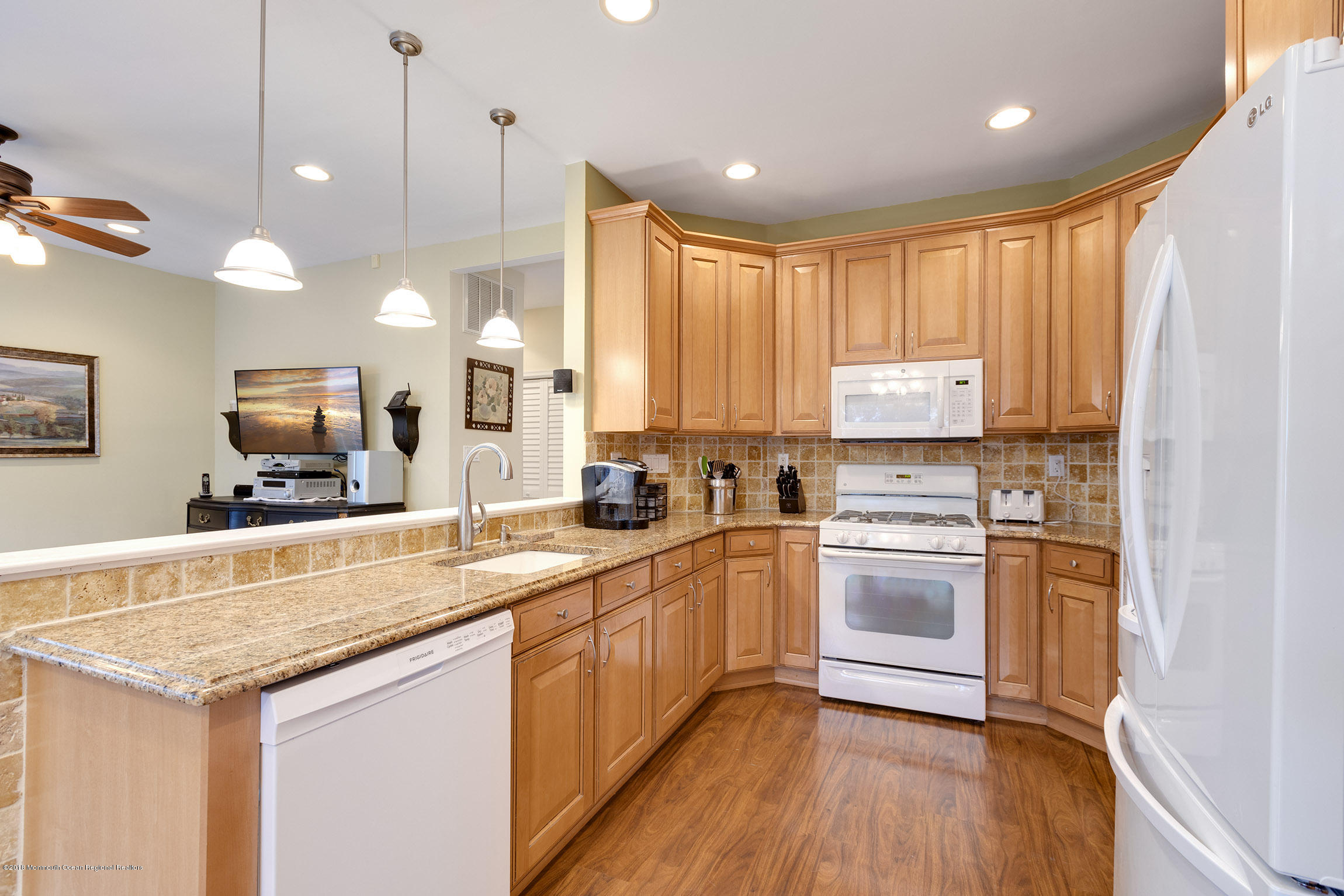 1 Lafayette Key Colts Neck, NJ 07722 - Photo 8 of 25 a kitchen with stainless steel appliances granite countertop a sink a stove a refrigerator and island with wooden floor