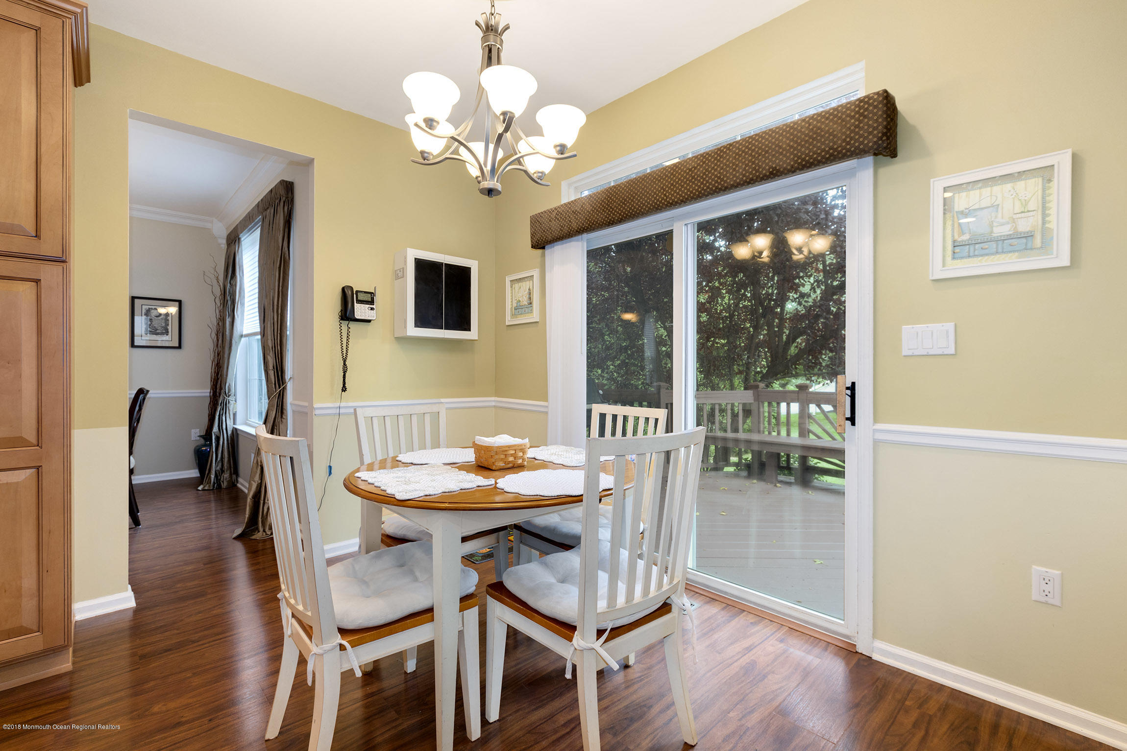 1 Lafayette Key Colts Neck, NJ 07722 - Photo 9 of 25 a dining room with wooden floor a chandelier a wooden table and chairs