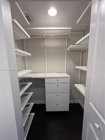 a room with closet and a lamp