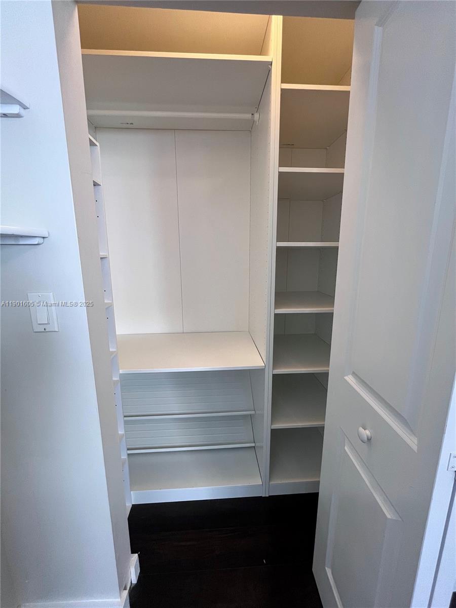 601 Northeast 23rd Street, Unit 606 Miami, FL 33137 - Photo 14 of 26 a view of walk in closet with empty racks