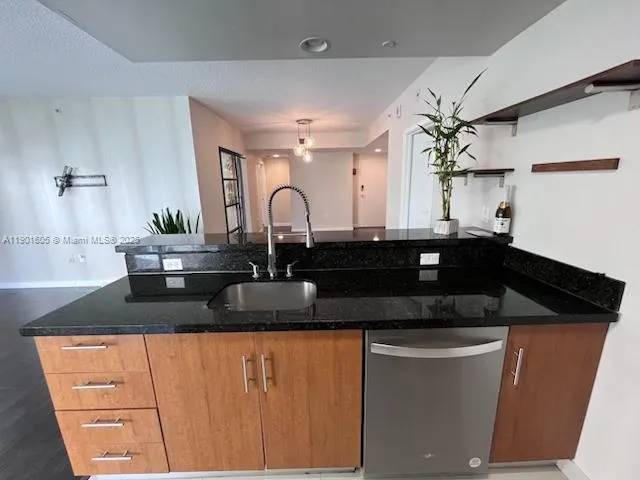 a kitchen with granite countertop a sink and cabinets