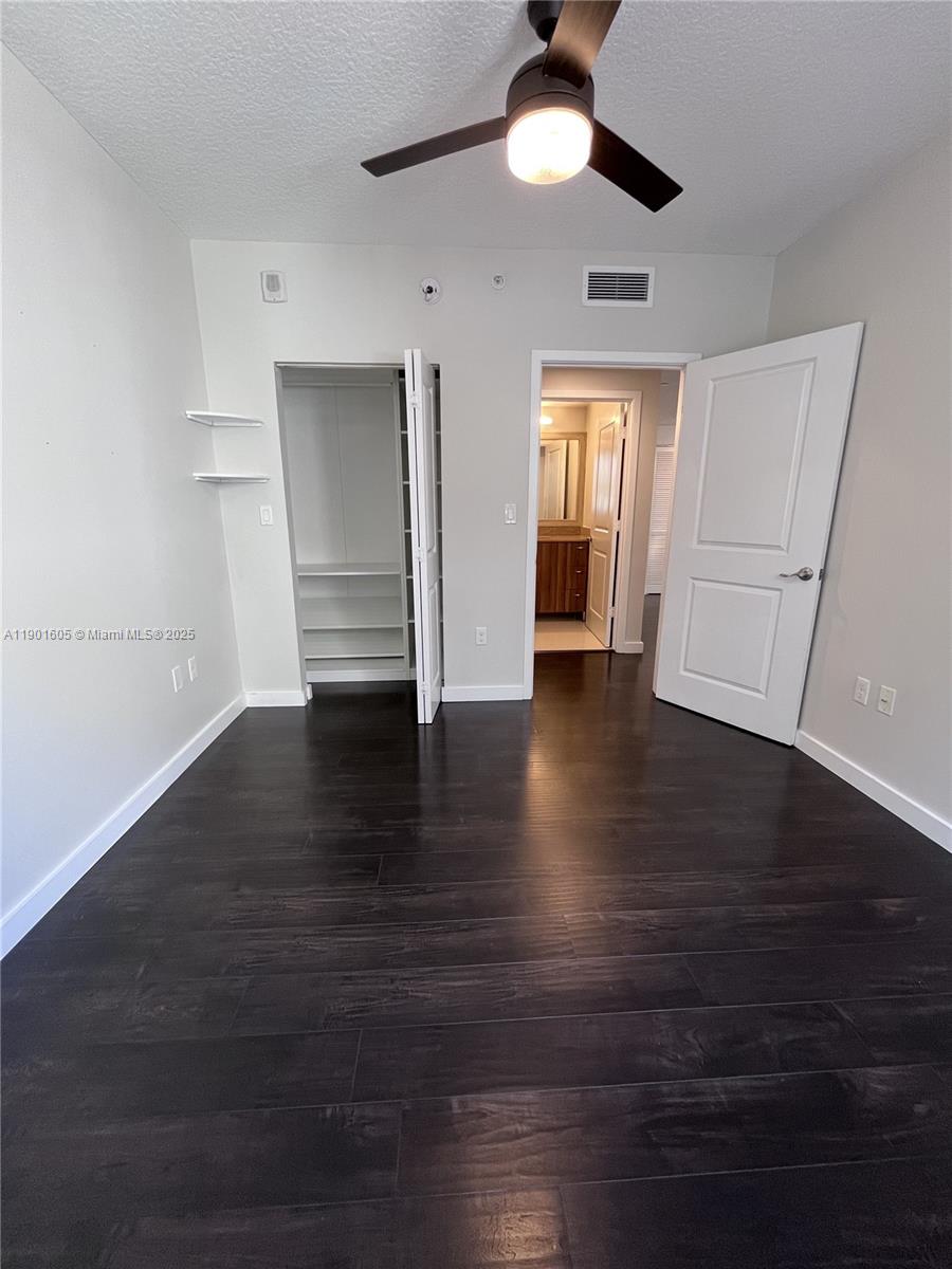 601 Northeast 23rd Street, Unit 606 Miami, FL 33137 - Photo 7 of 26 an empty room with wooden floor closet and windows