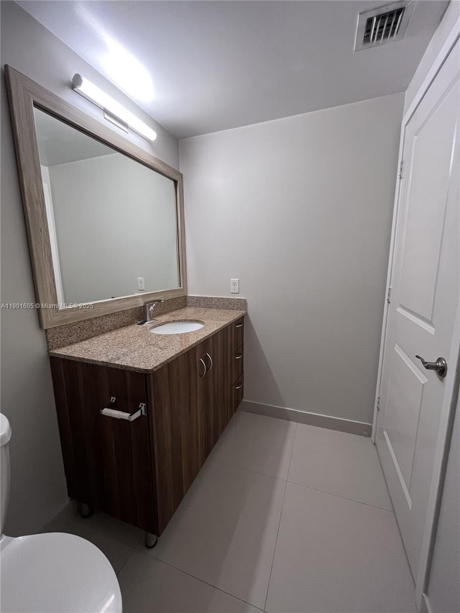 601 Northeast 23rd Street, Unit 606 Miami, FL 33137 - Photo 9 of 26 a bathroom with a sink and a mirror