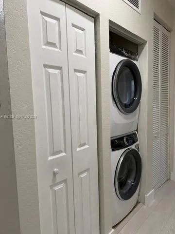 a view of a hallway with washer and dryer