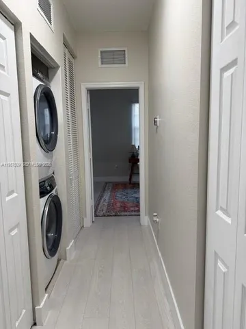 a view of a hallway with washer and dryer