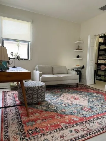 a living room with furniture and a rug