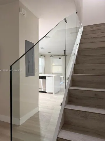 a view of entryway and hall with wooden floor
